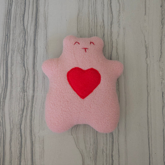 Brown bear with a red heart on the belly and an embroider face with red Theard